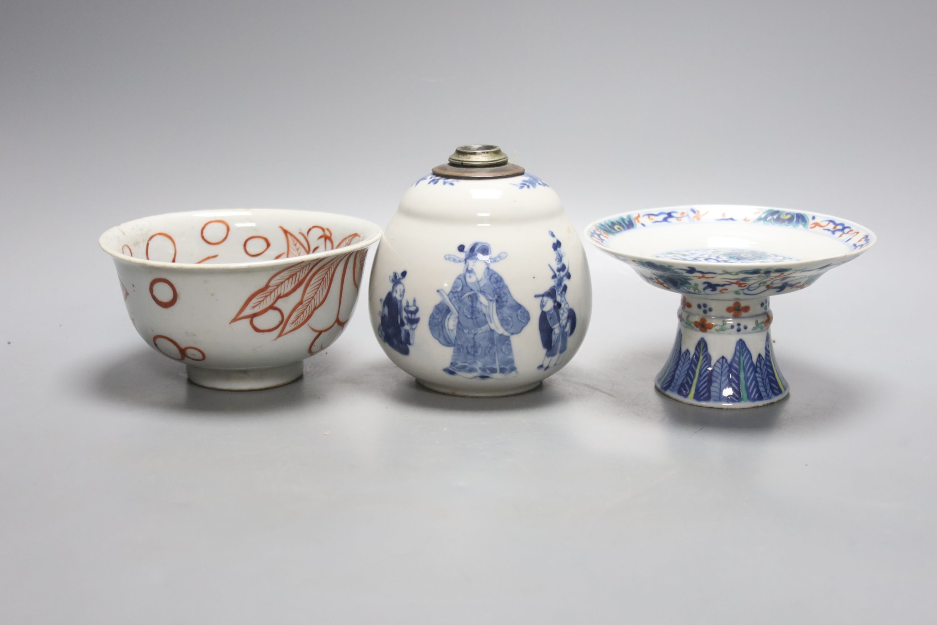 A Chinese blue and white water pipe vessel, a doucai stem dish and a Japanese Imari bowl, 19th century, (3)